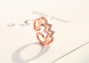 Detail of rose gold double layer zig-zag ring featuring micro-paved crystal accents