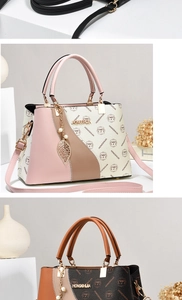 Detail view of stylish tri-color patchwork handbag with pearly leaf charm and brand pattern