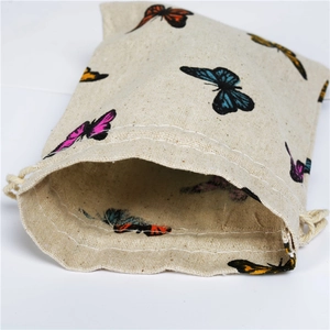 Close-up of cotton linen drawstring pouch with colorful butterfly patterns and texture