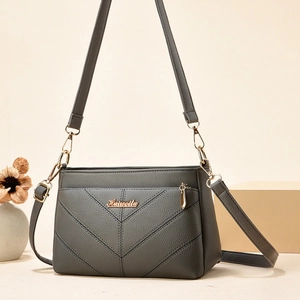 Sac à bandoulière gris foncé pour femme avec coutures en V et finitions dorées