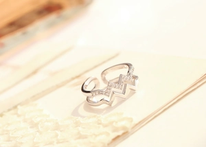 Macro detail of double-layer silver ring with wavy sawtooth zircon and polished lines