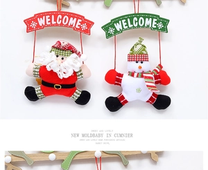 Detail of plush Santa and Snowman welcome signs with festive red and green hanging ropes