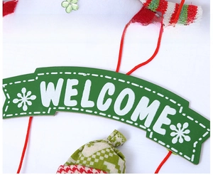 Macro detail of Christmas snowman hanging ornament with knitted scarf and Welcome sign
