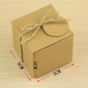 Close-up of a 5cm kraft paper gift box with twine ribbon and a round scalloped tag