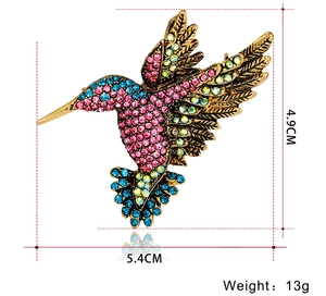 Detailed view of colorful rhinestone hummingbird brooch with 4.9cm x 5.4cm dimensions