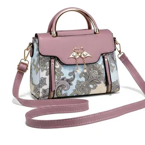 Vue détaillée du sac floral avec fermoir flamant rose doré et pendentif en perle