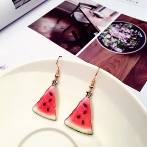 Summer watermelon slice drop earrings with red and green finish on white ceramic plate