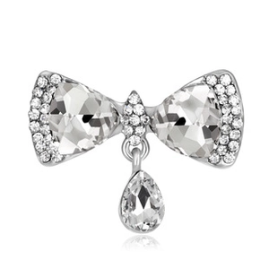 Close-up of sparkling butterfly brooch with crystal pavé and pear-shaped pendant drop