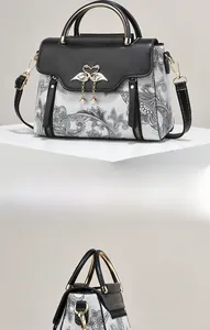 Détail du sac à main contrasté avec motif paisley et boucle de cygne en perles