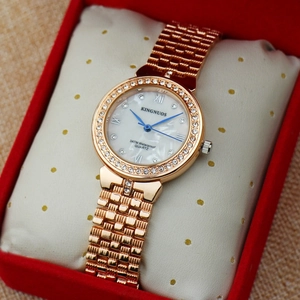 Close-up of rose gold rhinestone watch with white dial in a red luxury gift box