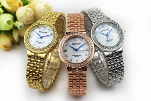Detailed shot of three diamond-set quartz watches in gold, rose gold and silver finish
