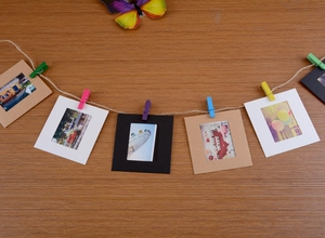 DIY paper photo frames set with colorful wooden clips and jute rope for wall display