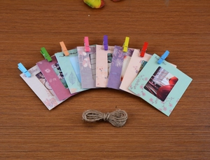 Set of colorful paper photo frames with mini wooden clips and twine for wall decoration