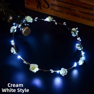 Detail of LED glowing hair wreath with cream white roses on a brown rustic wire base