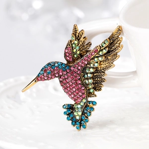 Exquisite hummingbird brooch with colorful rhinestones on a vintage gold metal base