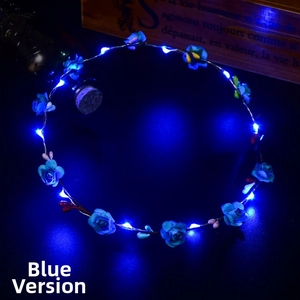 Detailed close-up of a blue floral headband with luminous LED lights in dark setting