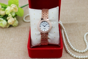 Elegant rose gold watch with rhinestone bezel in a gift box with luxury pearls