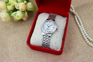Elegant silver rhinestone women watch presented in a luxury red gift box on a woven mat