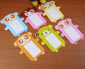 Close-up of colorful cartoon paper frames in animal shapes on a rustic wooden desk
