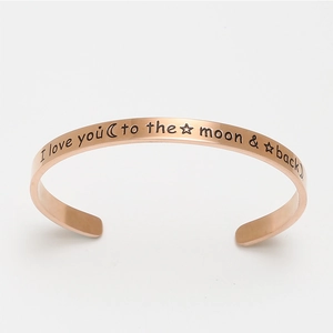 Rose gold open cuff bracelet engraved with I love you to the moon and back text