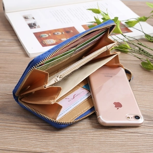 Internal view of blue embroidered wallet with card slots and zipper coin compartment