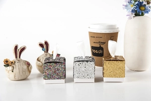 Three-piece glitter gift box set in gold, silver and colorful finishes with a white ribbon top