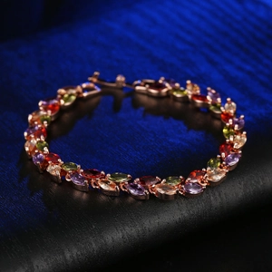 Colorful marquise-cut crystal bracelet with rose gold plating on a dark blue background