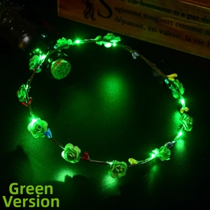 Detail of green LED floral headpiece with glowing roses and festive berry accents