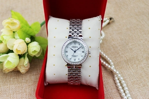 Detail of luxury rhinestone bezel watch with mother of pearl dial in red gift box