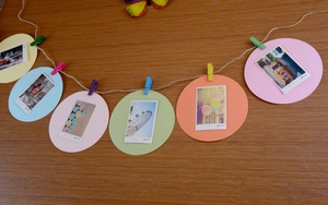 Colorful round paper photo frames with mini wooden clips and hemp rope for DIY wall decor