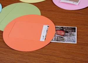 Detail of colorful faux leather photo card holders with visible stitching and clear slot