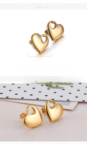 Detailed view of 15mm hollow heart stud earrings in 18K vacuum gold plated titanium steel