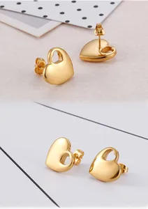 Detail of hollow heart-shaped gold-plated titanium steel earrings with butterfly backings