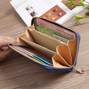 Internal view of blue embroidered wallet with card slots and golden U-shaped zipper