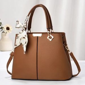 Chic brown textured leather handbag with a floral silk scarf and gold metal buckles