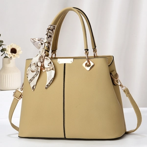 Khaki pebbled leather handbag with decorative silk scarf and adjustable strap for women