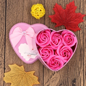 Detail of pink heart-shaped tin box with six soap roses and a romantic greeting card