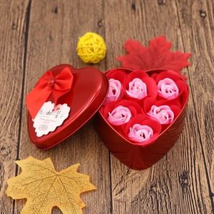 Detail of heart-shaped metal gift box with six soap roses and silk bow decoration
