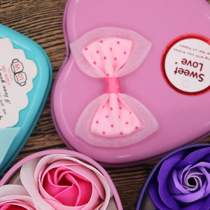 Macro shot of heart-shaped tin gift box with rose soap flowers and sweet love bow