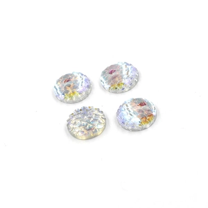 Macro view of four round resin fish scale cabochons with iridescent holographic finish