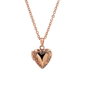Rose gold heart-shaped locket necklace with vintage floral engraving and cross chain
