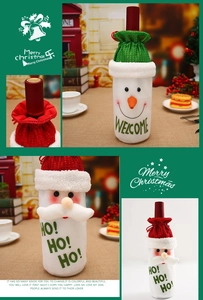 Detail of Christmas wine bottle bags with sequin hats and plush snowman and Santa embroidery