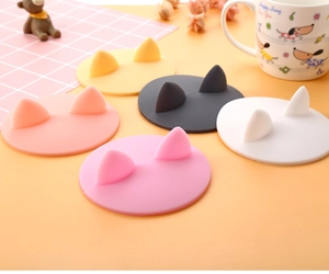 Close-up view of multiple colorful silicone cup lids featuring cute 3D cat ear designs