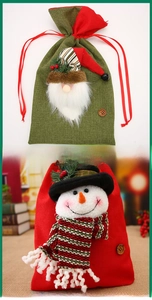 Detail of burlap Christmas gift bags with 3D Santa and snowman, drawstring and wood button