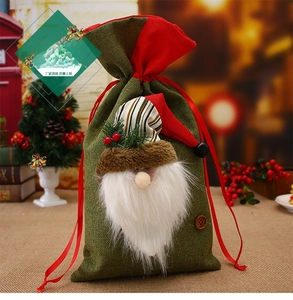 Detail of green burlap Christmas sack with Santa gnome and red drawstring ribbon