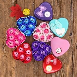 Detailed overhead view of assorted heart-shaped soap rose flower gift boxes in varied colors