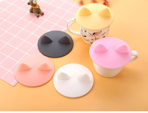 Detailed view of colorful silicone cup lids with creative 3D cat ear designs on mugs