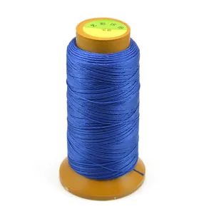 Royal blue polyester braided cord on brown spool for DIY jewelry making and beadwork