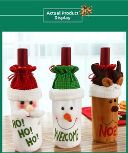 Detailed view of Christmas wine bottle covers with Santa, Snowman and Reindeer designs