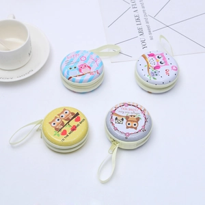 Set of round tinplate coin purses with cute owl illustrations and zipper closures